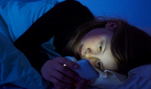 woman-cellphone-bed-nightime